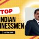 Gautam Adani standing confidently in front of Adani Group logo, representing his leadership in global business.